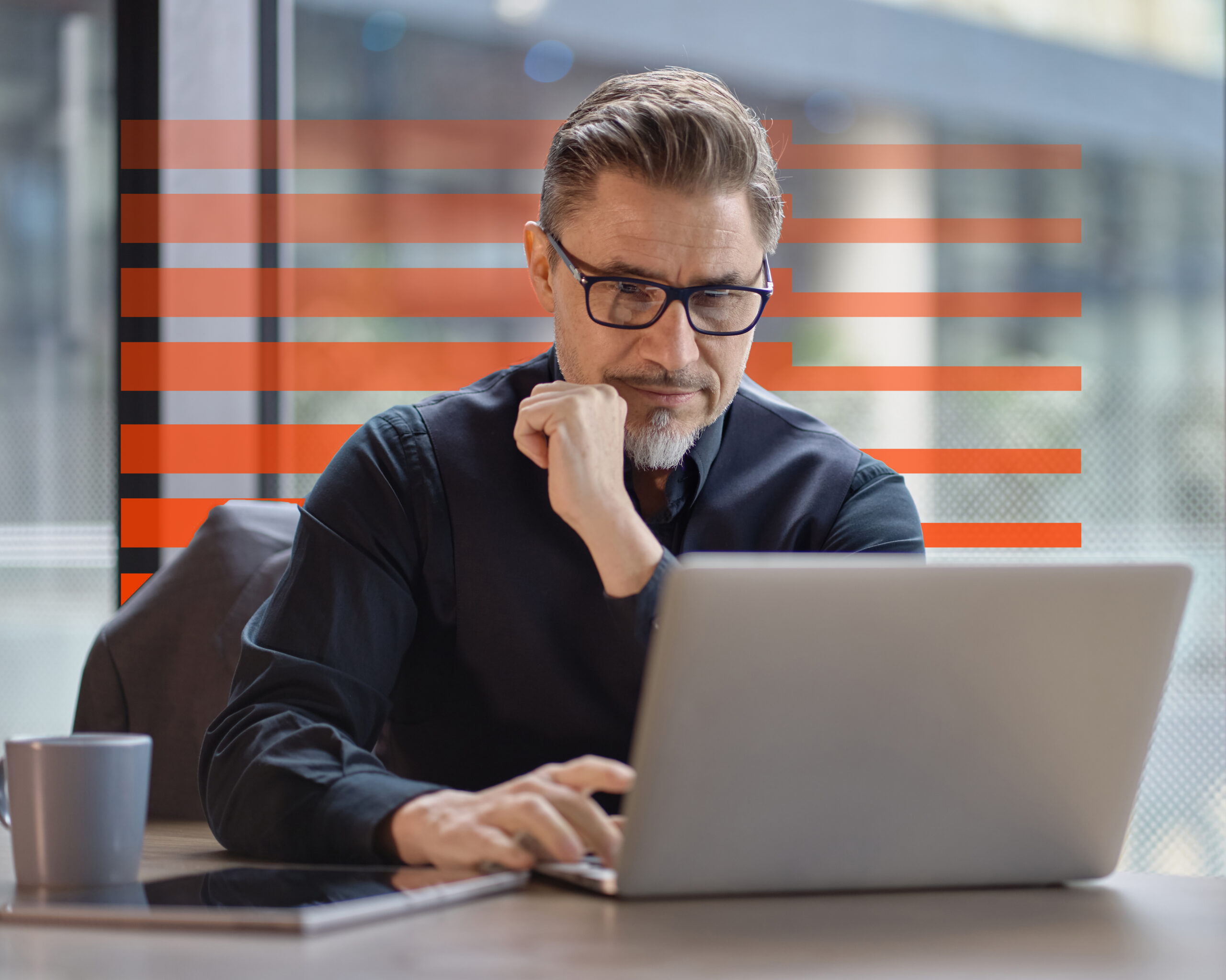 Business portrait - businessman using laptop computer in office, thinking. Happy middle aged man, entrepreneur working online.