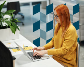 Woman with red hair working on laptop